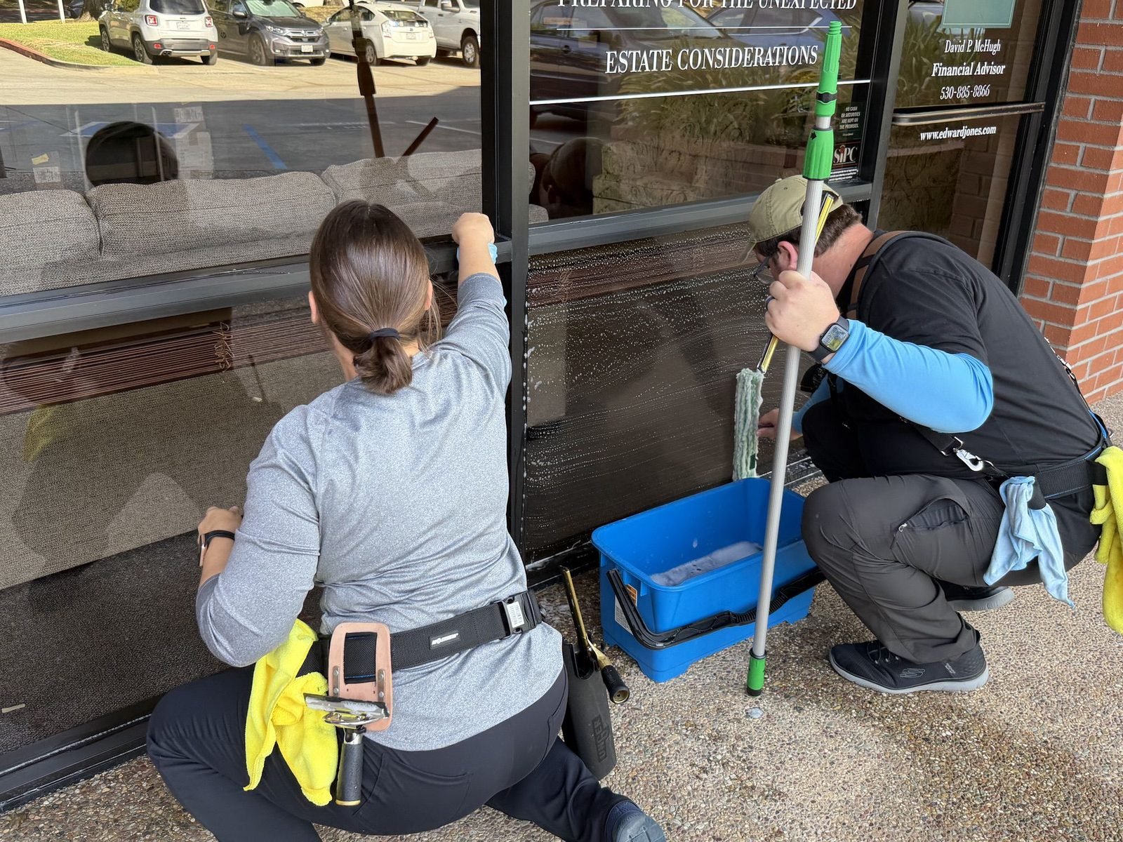 Alex and Molly of Radiant Window Care cleaning storefront windows for a business in Auburn, CA