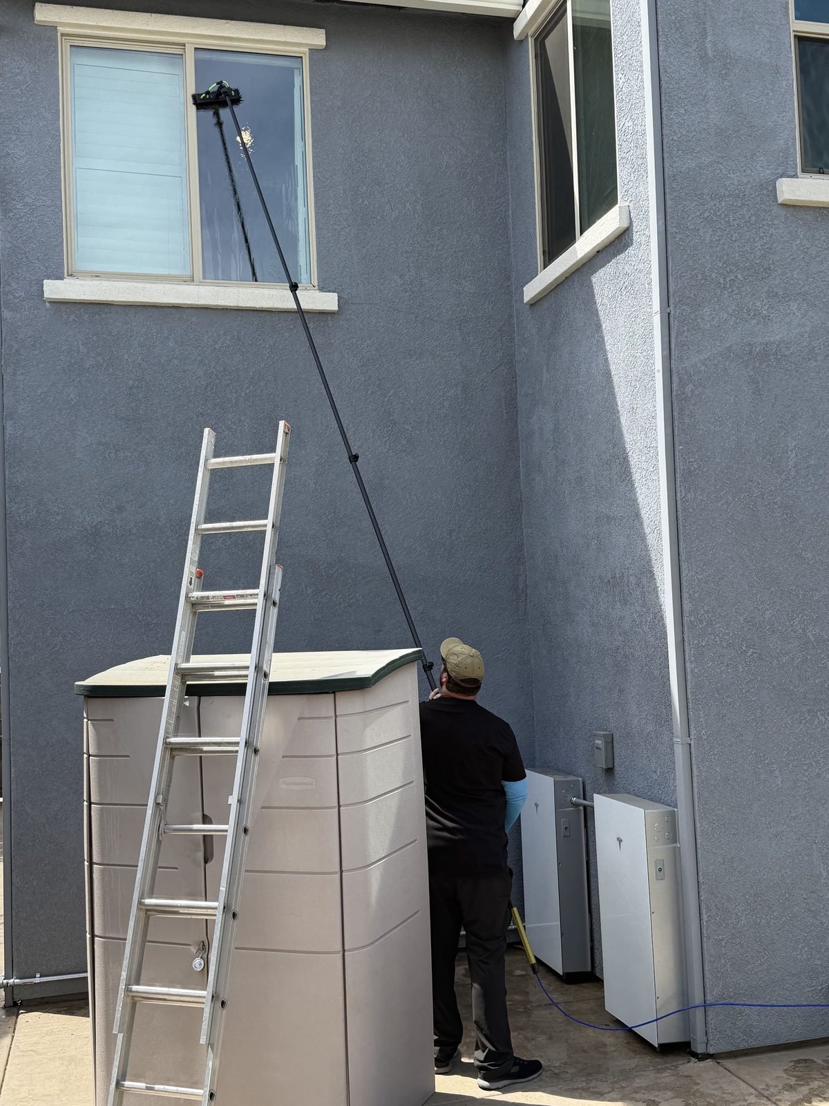 Cleaning second story windows with a water fed pole at a home in Anatolia, Rancho Cordova, CA