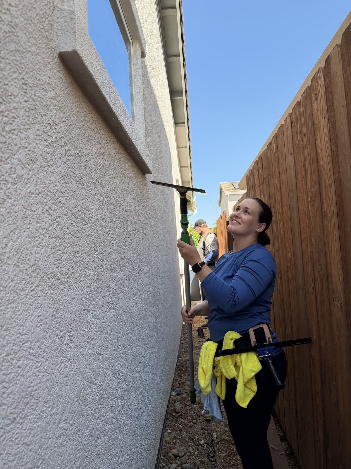 Molly of Radiant Window Care cleaning a second story window in Anatolia, Rancho Cordova, CA