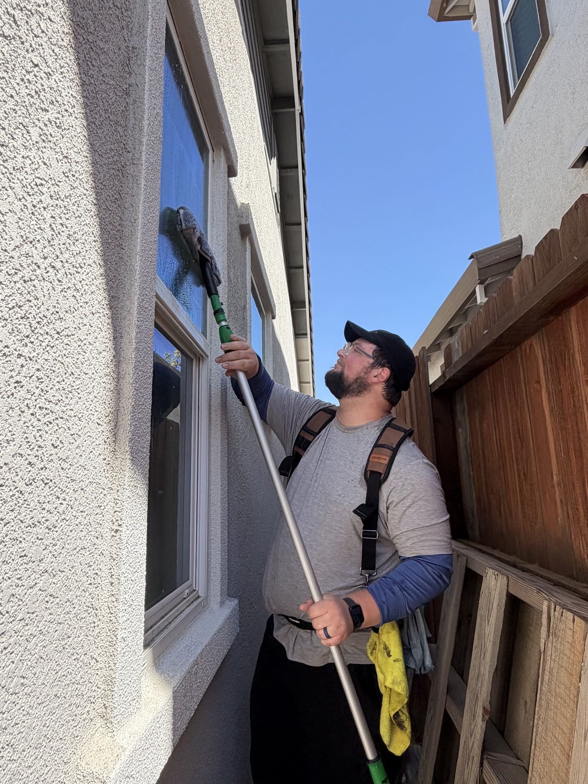 Cleaning windows from the ground with a water fed pole at a home in Anatolia, Rancho Cordova, CA