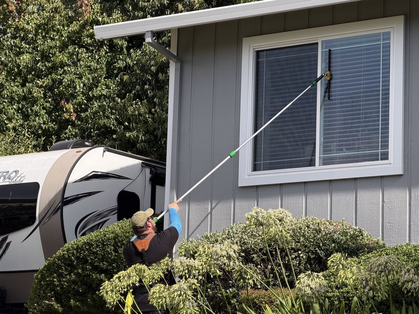 Cleaning windows with a water fed pole at a home in Auburn, CA